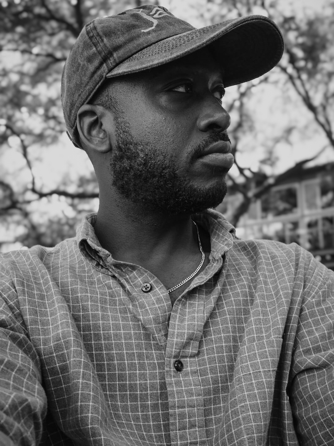 TAVE, founder and photographer of Taymo Digital, in a black-and-white portrait